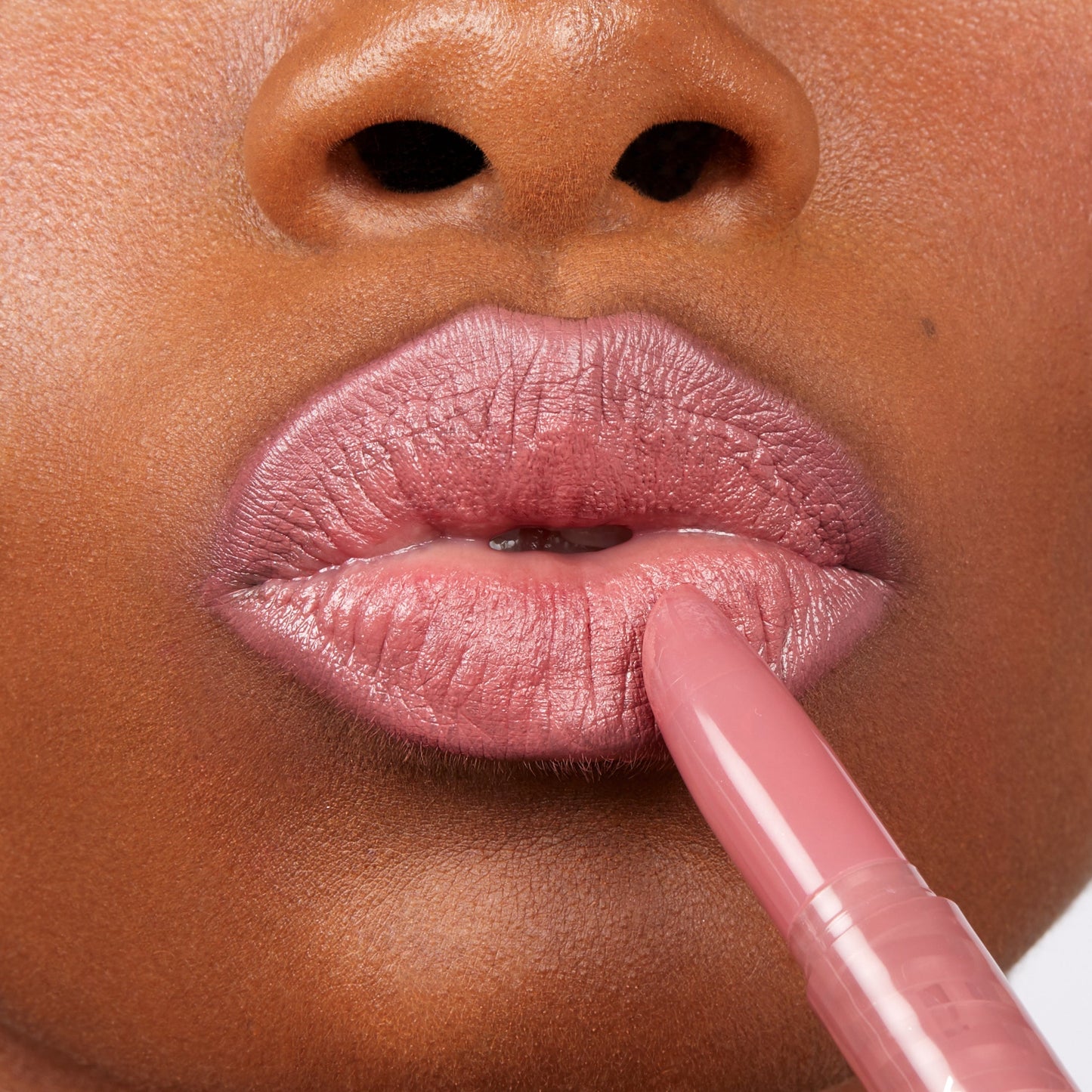 ColourPop Lippie Stix in Cami gliding onto lips, depositing a dusty rose‑mauve shade with a creamy sheen; tight close-up highlights smooth application, precise bullet tip, and true-to-color payoff.