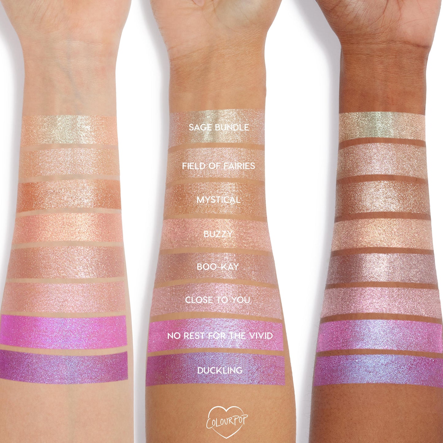 Boo-Kay Jelly Much Shadow swatch gleams on three forearms, shown with labeled rows of other shades, displaying a shimmery pink finish across light, medium, and deep skin tones for easy comparison of ColourPop Jelly Much Shadow colors.