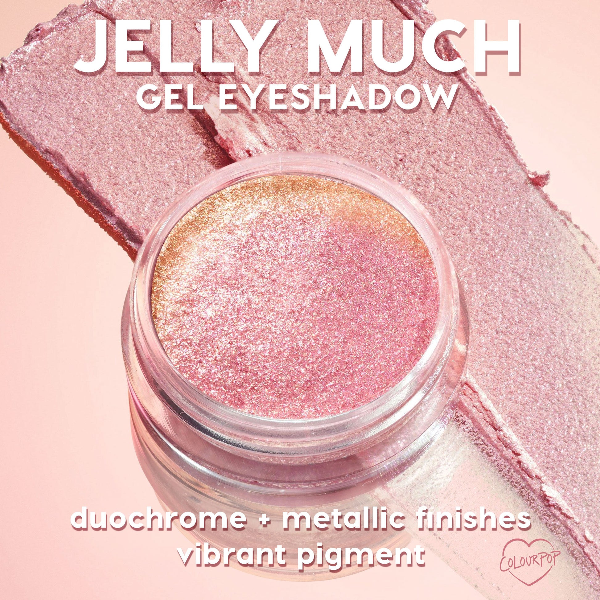 Open jar of ColourPop Jelly Much Shadow, Buzzy, gleams with duochrome pink-to-gold metallic shimmer, resting on matching swatches over a blush-pink backdrop; gel eyeshadow formula shows vibrant pigment and reflective, long-wear sparkle.