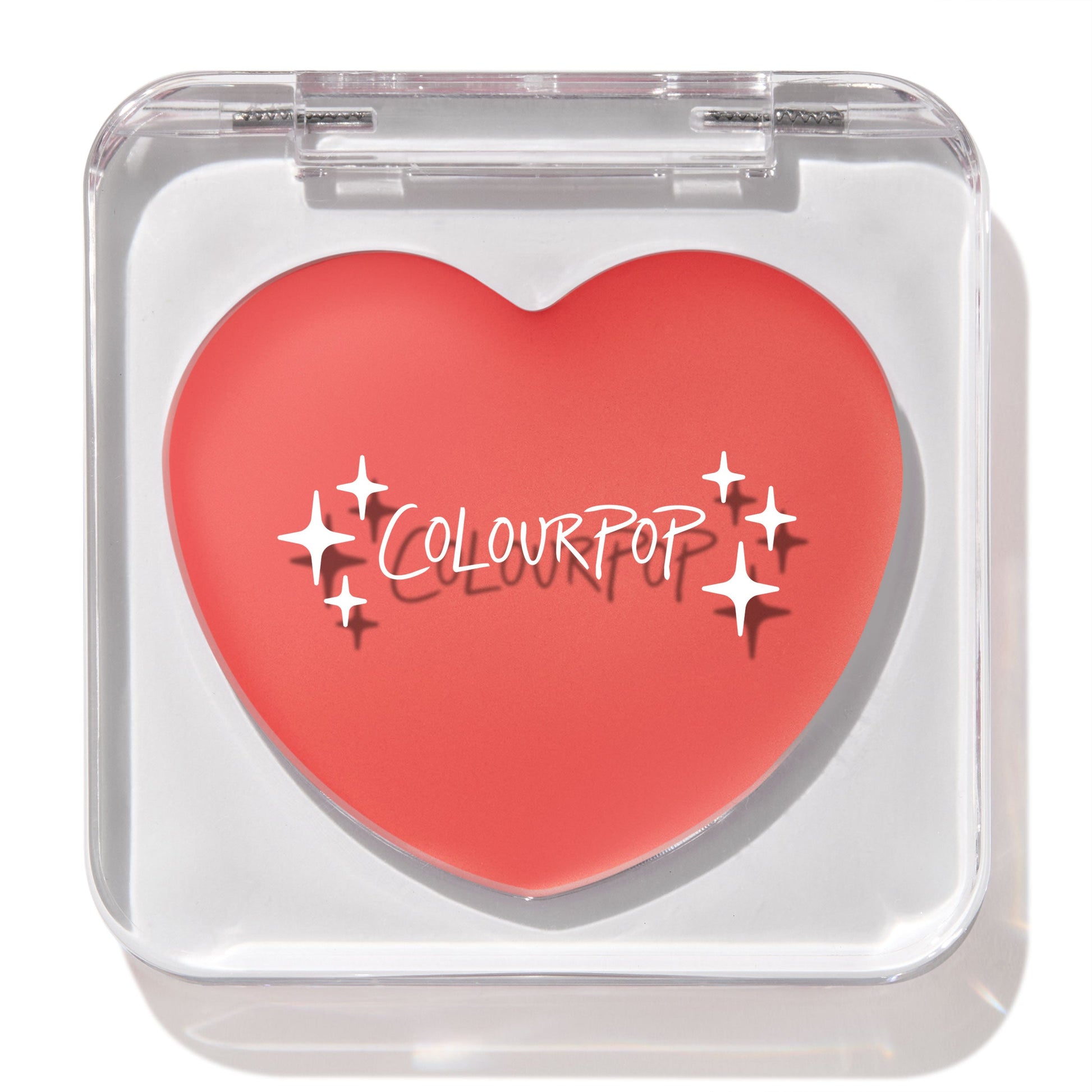 Heart-shaped Baby Bunny ColourPop Lip and Cheek Balm shown closed in a clear square compact, coral-pink tint with white sparkle graphics and ColourPop logo, displayed under studio light on a white background.